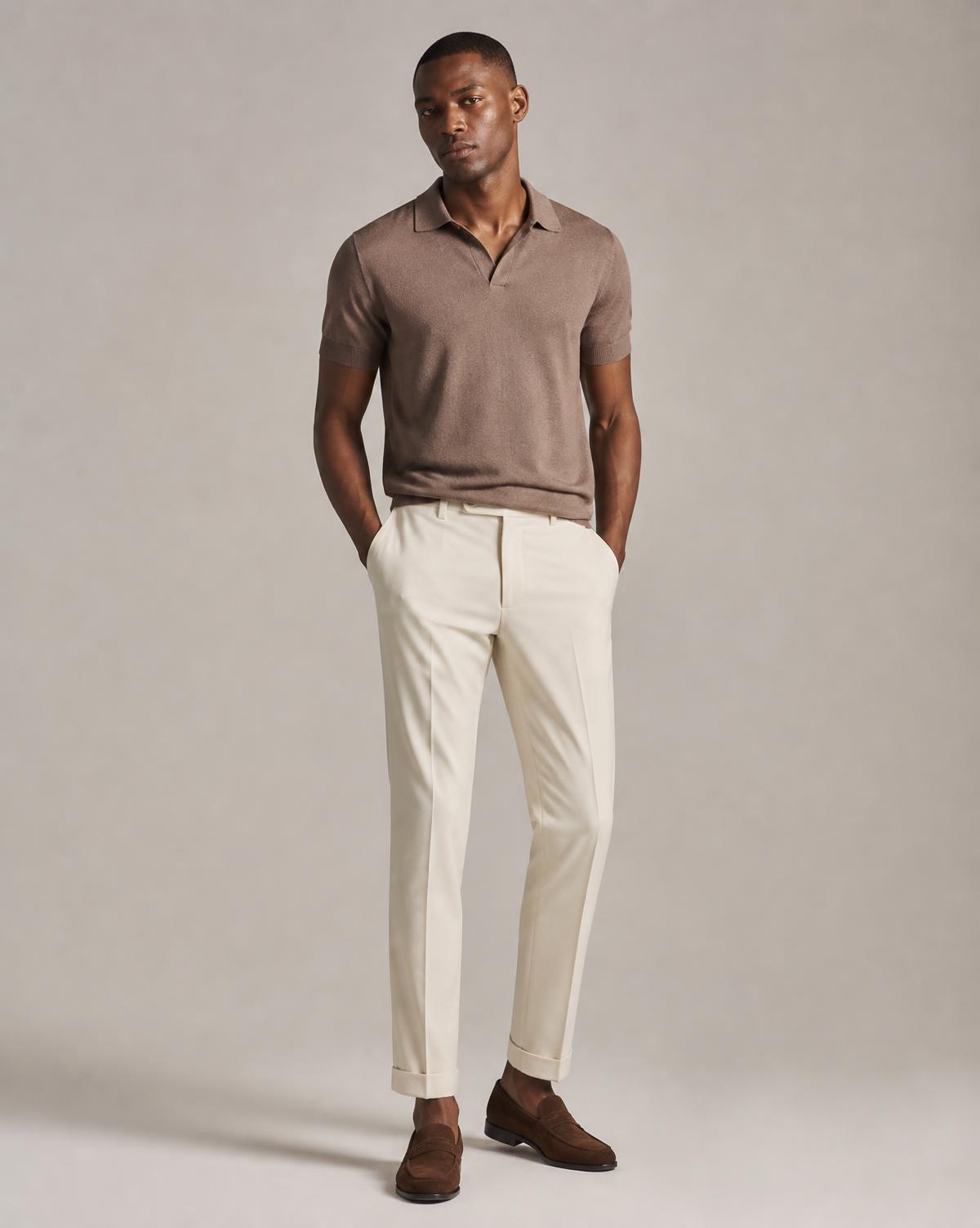 Male model wearing a premium knitted polo shirt and tailored trousers